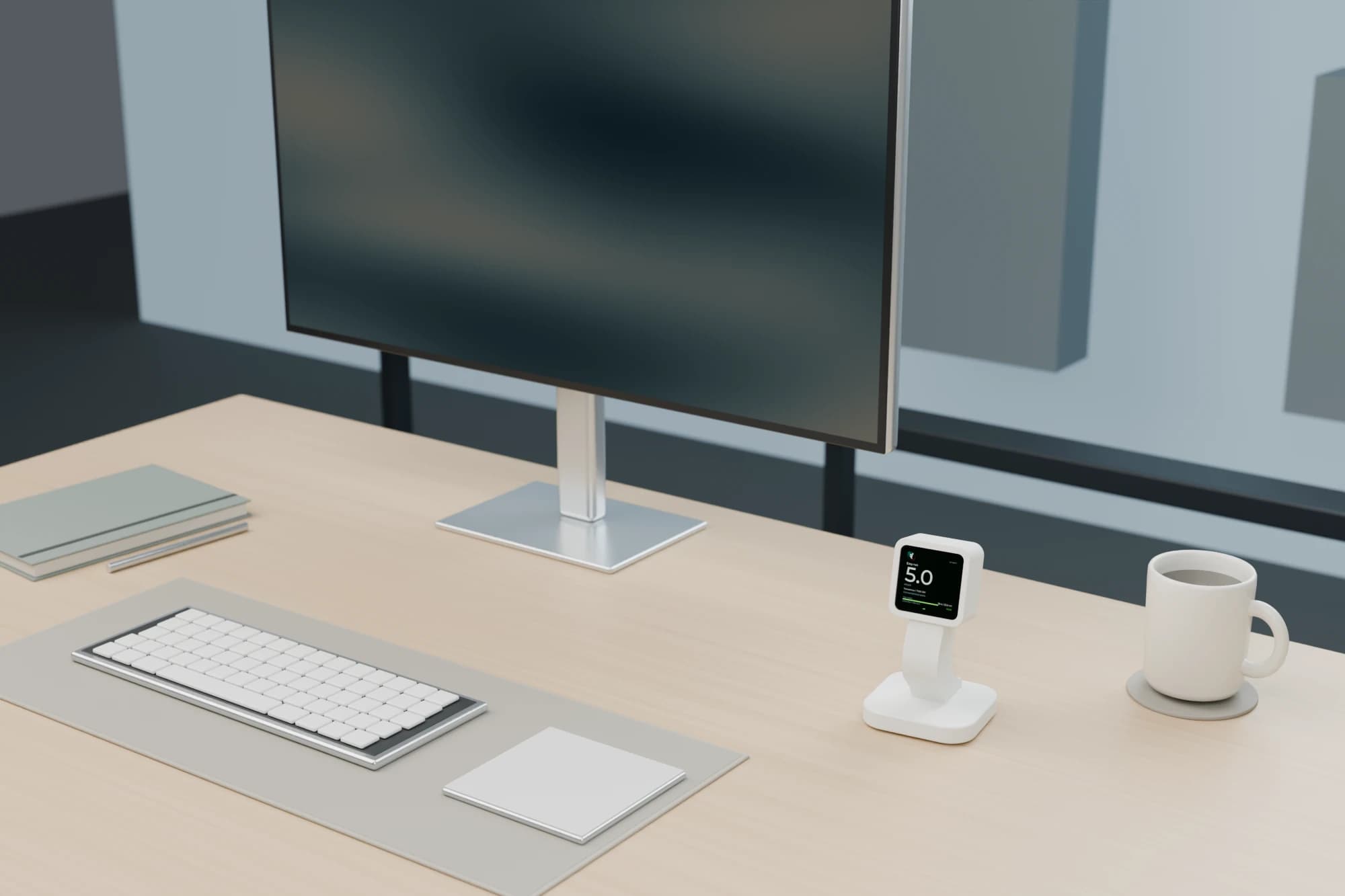 CAD render of the matte-white Desk Buddy beside a monitor, keyboard, notebook, and coffee on a light oak desk